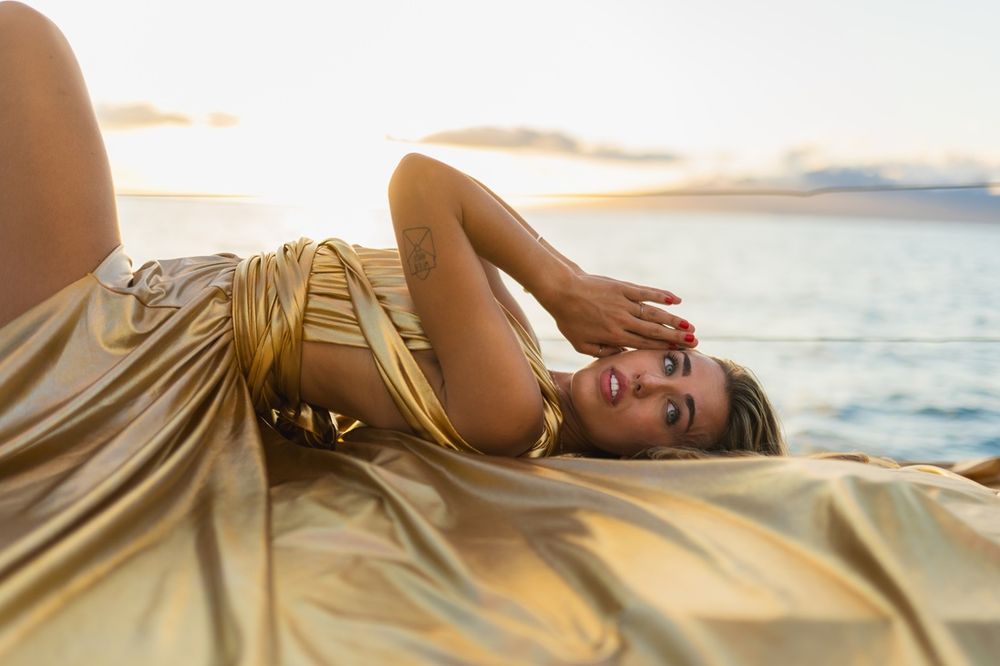 Maui flying dress photographer photo against beautiful Maui sunset Saltydogsailingmaui sailing boat  by ohwowfotos.