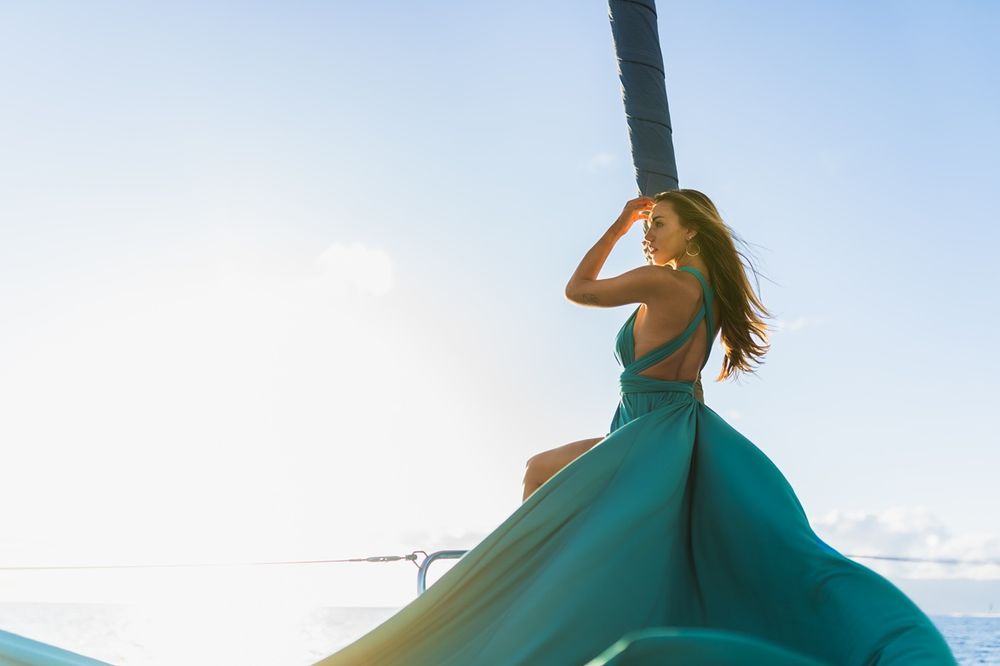 Maui flying dress photographer photo against beautiful Maui sunset Saltydogsailingmaui sailing boat  by ohwowfotos.
