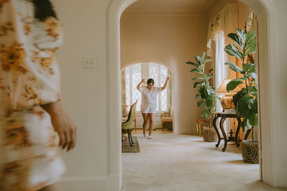 Bride dancing while getting ready for her wedding Lafayette event space