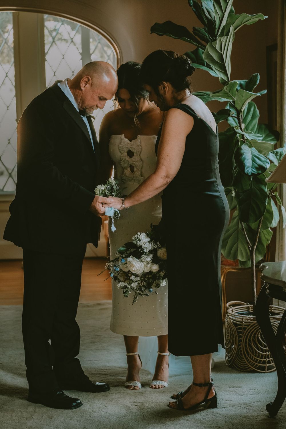 family praying before ceremony Lafayette event space