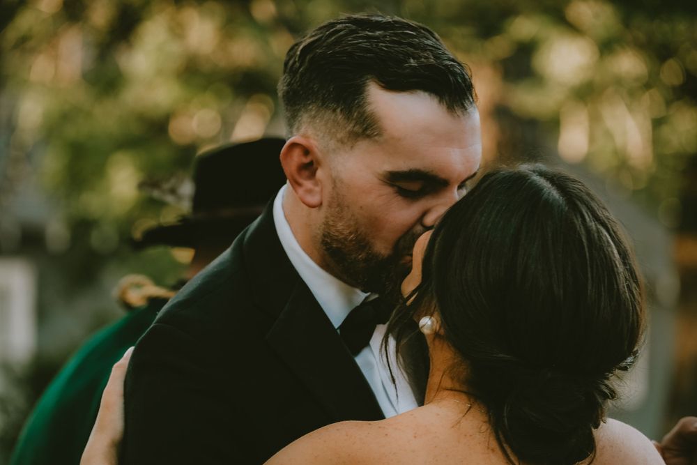 Bride and groom first kiss outdoor wedding venue Lafayette la