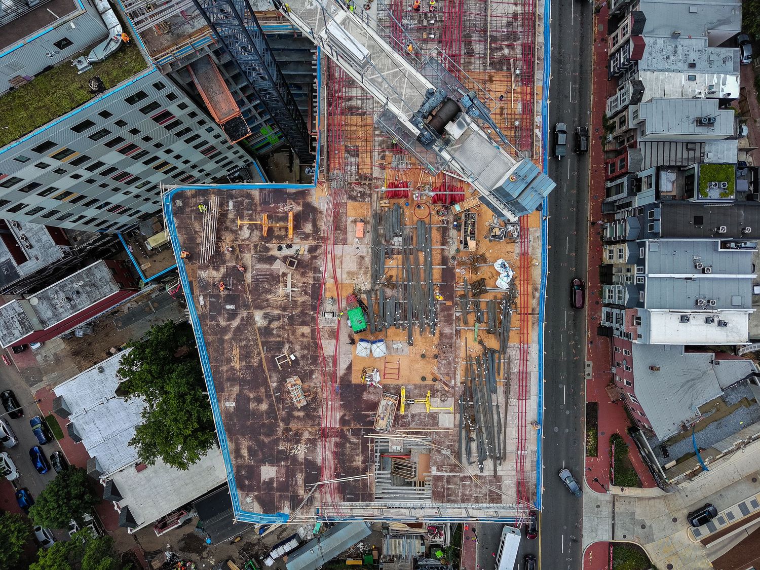 Aerial view of illuminated construction site at night showing building progress.