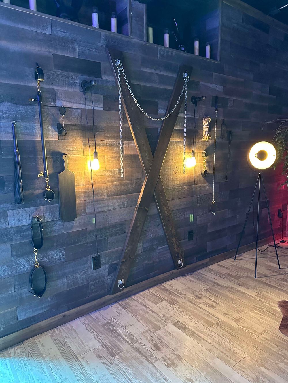 Collection of vintage-style light fixtures mounted on wood-paneled wall with warm ambient glow.