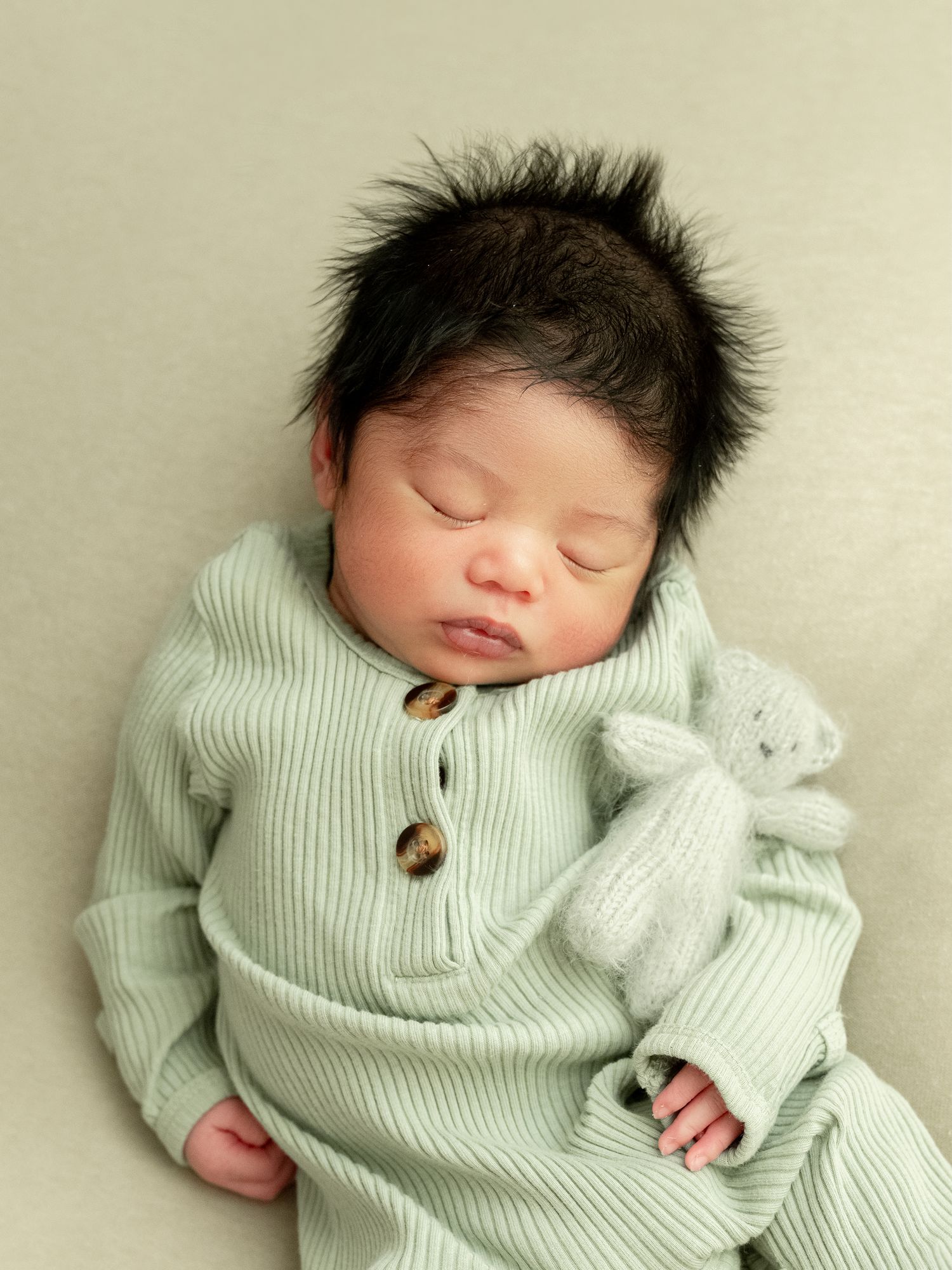 A close up macro shot of a sleeping baby's peaceful face showing soft skin and closed eyelids.