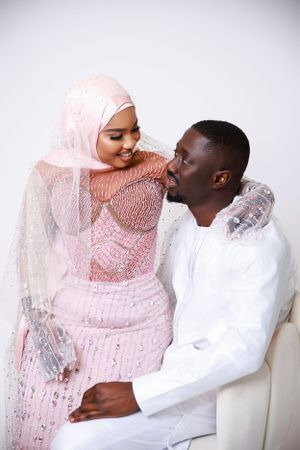 Intimate portrait of couple in traditional dress sharing joyful moment.