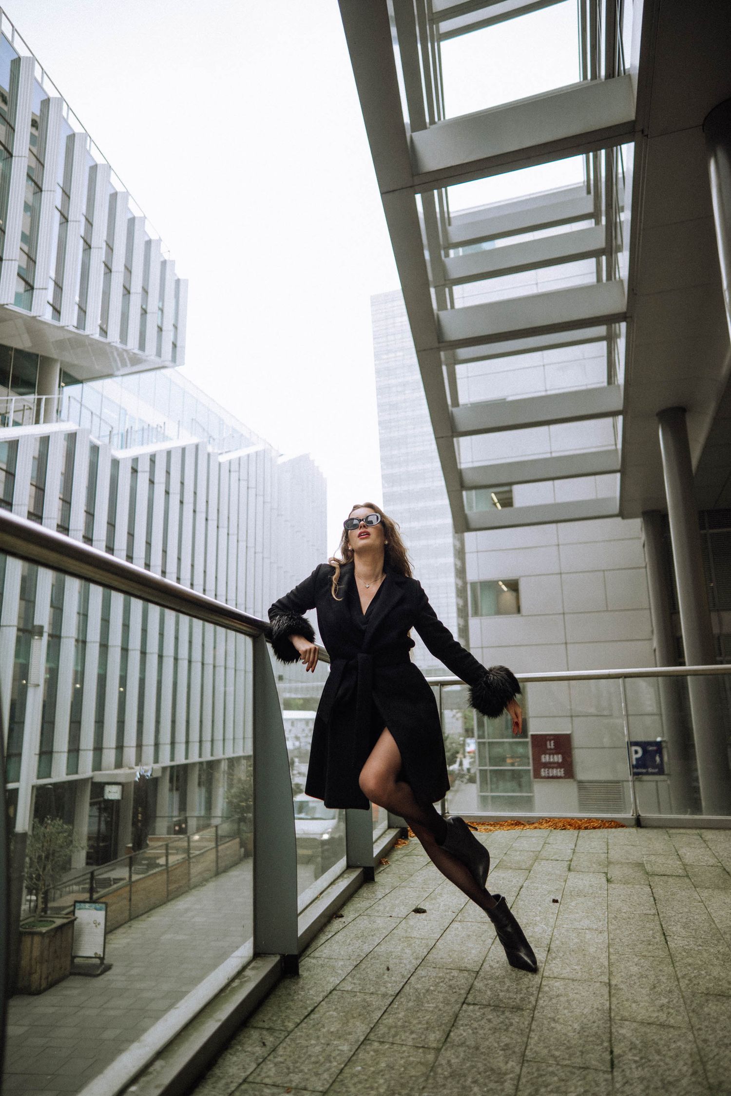 Artistic sequence showing dance movements in a modern architectural space with glass windows and concrete floors.