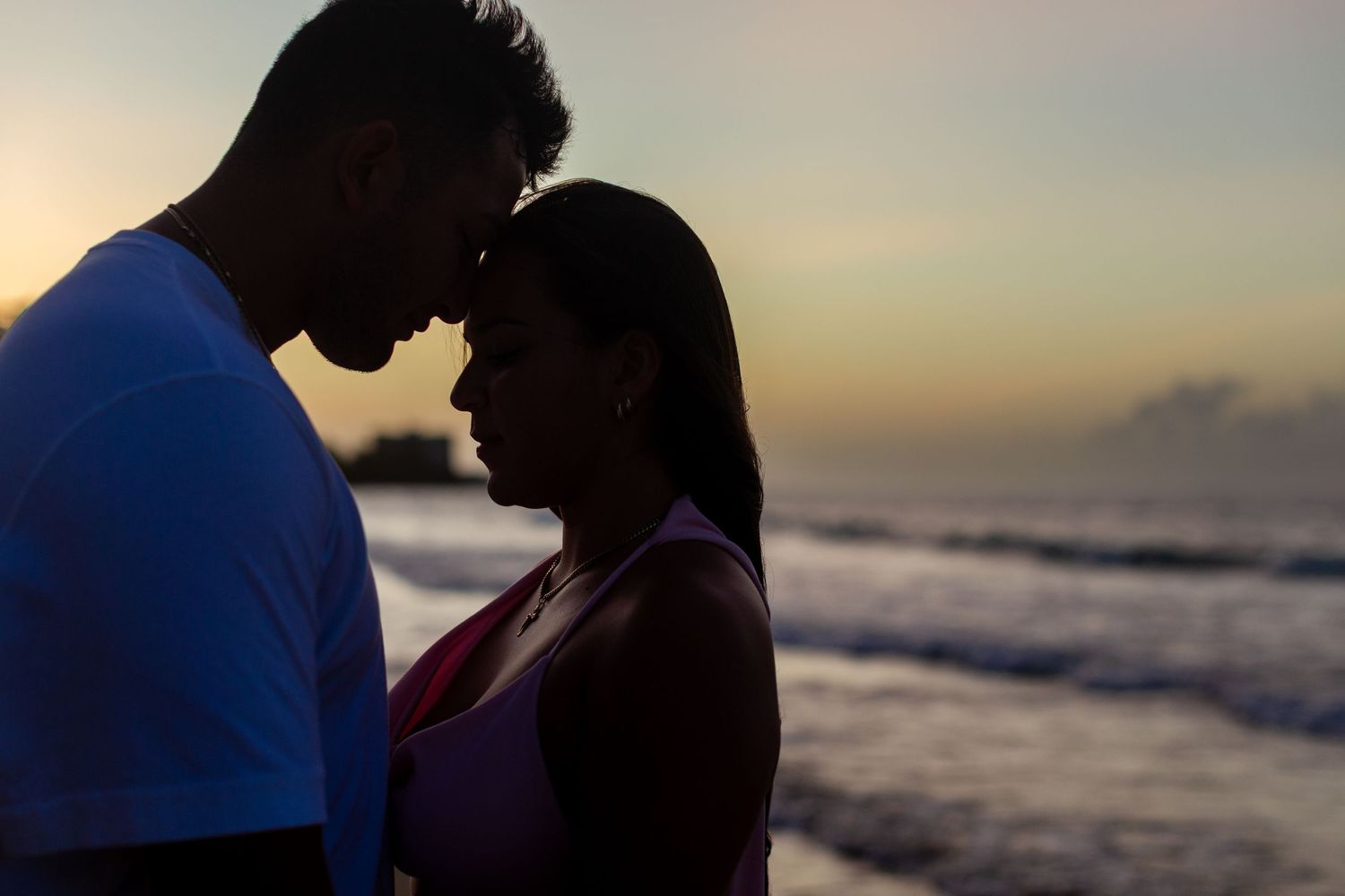 Sunset silhouette couples portrait at the beach in Isla Verde, Carolina, Puerto Rico.