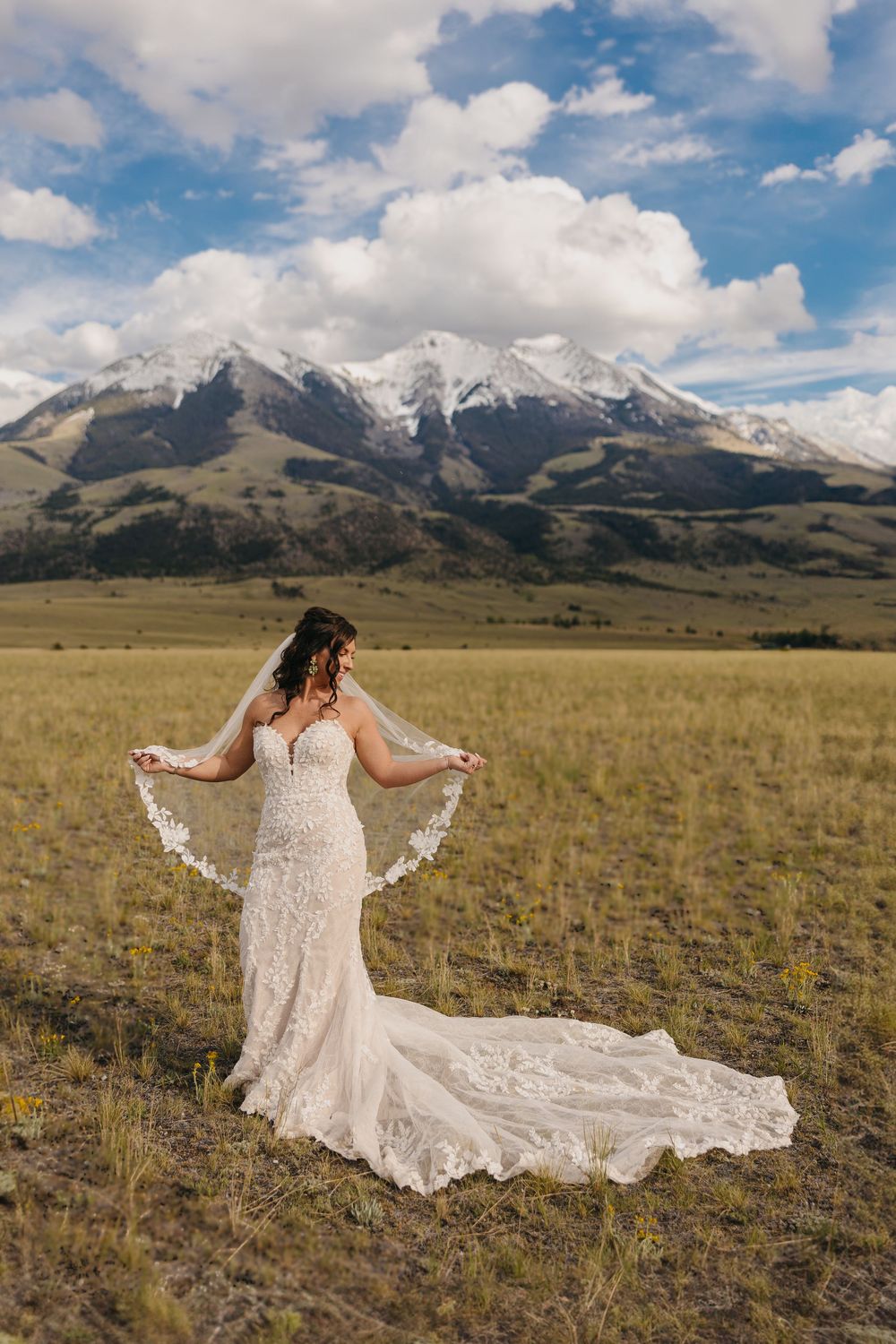 Paradise Valley bride plays with her veil under the Mountains in Pray, Montana captured by Emigrant Wedding Photographer Sabrina Marie