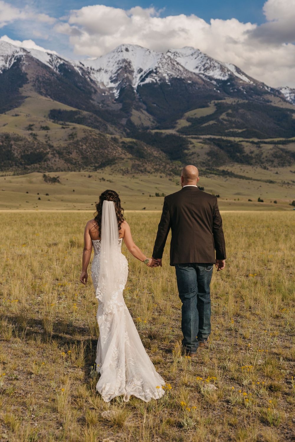 Pray, Montana bride & groom walk under the Mountains in Emigrant, Montana captured by Pray Montana Elopement Photographer Sabrina Marie