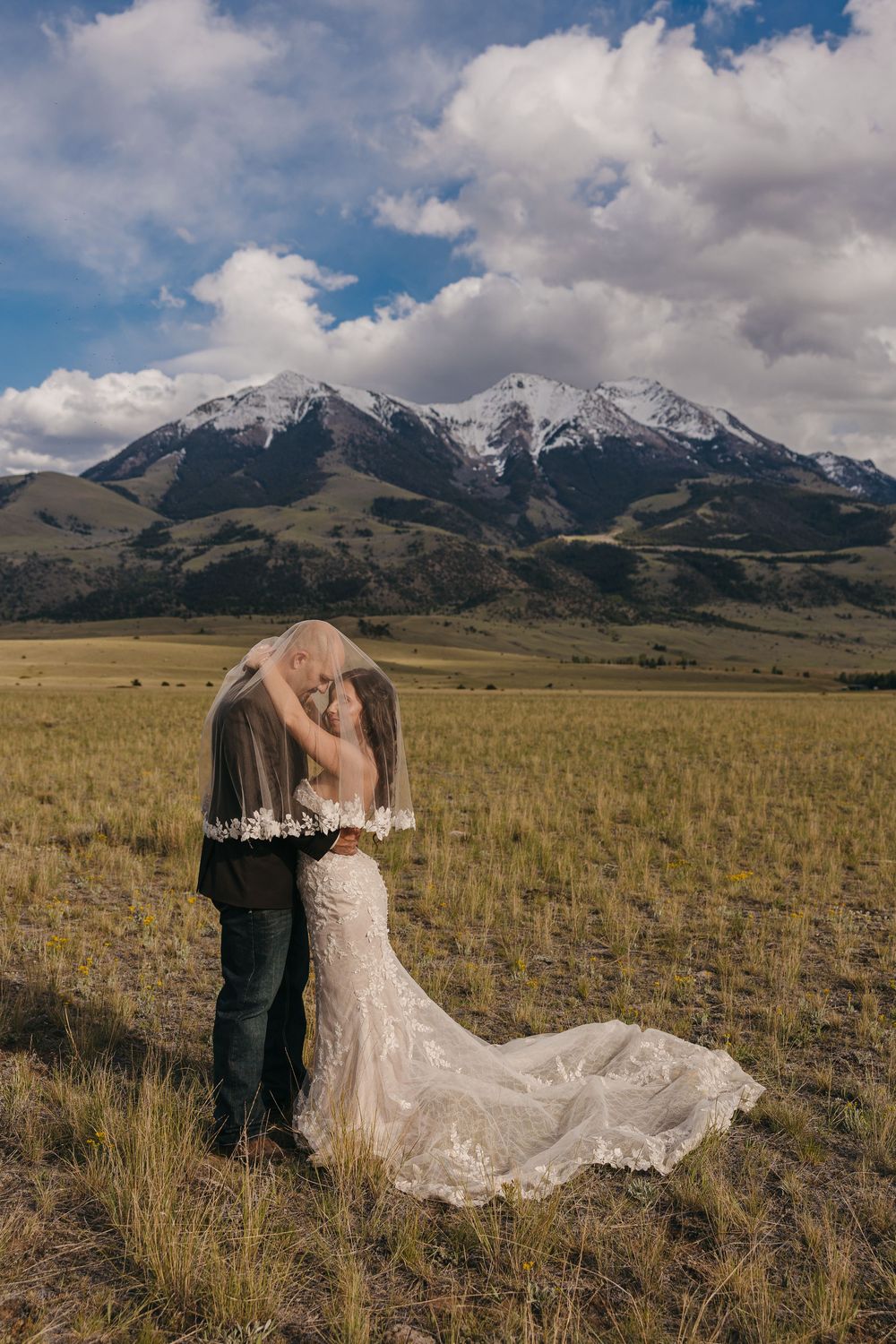 Paradise Valley Groom holds bride under the Mountains in Emigrant, Montana captured by Pray Montana Elopement Photographer Sabrina Marie