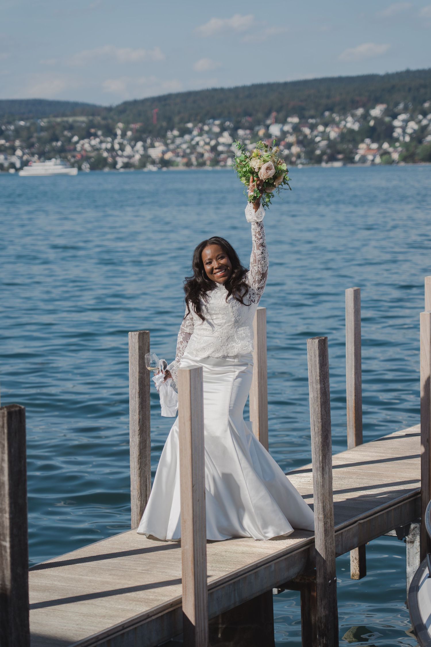 Pages from the groom's wedding speech clipped to a line against a scenic landscape photograph, creating a documentary-style wedding portrait