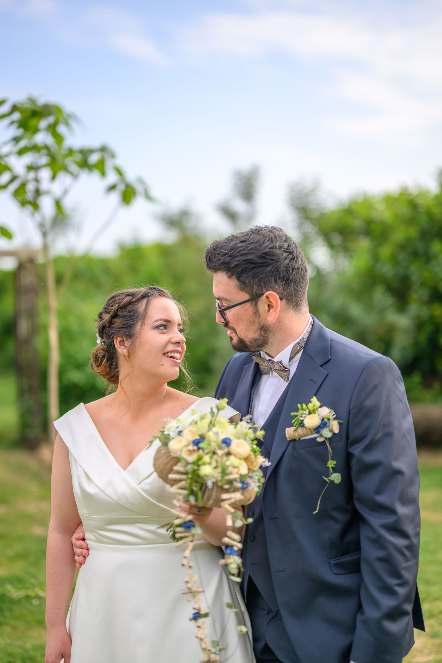 A romantic wedding couple poses in a series of elegant shots under stone archways at a historic European castle.