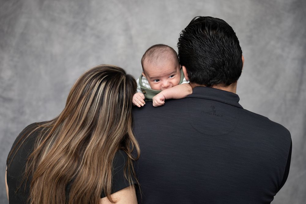 Family photoshoot with a loving mother and father to their newborn.