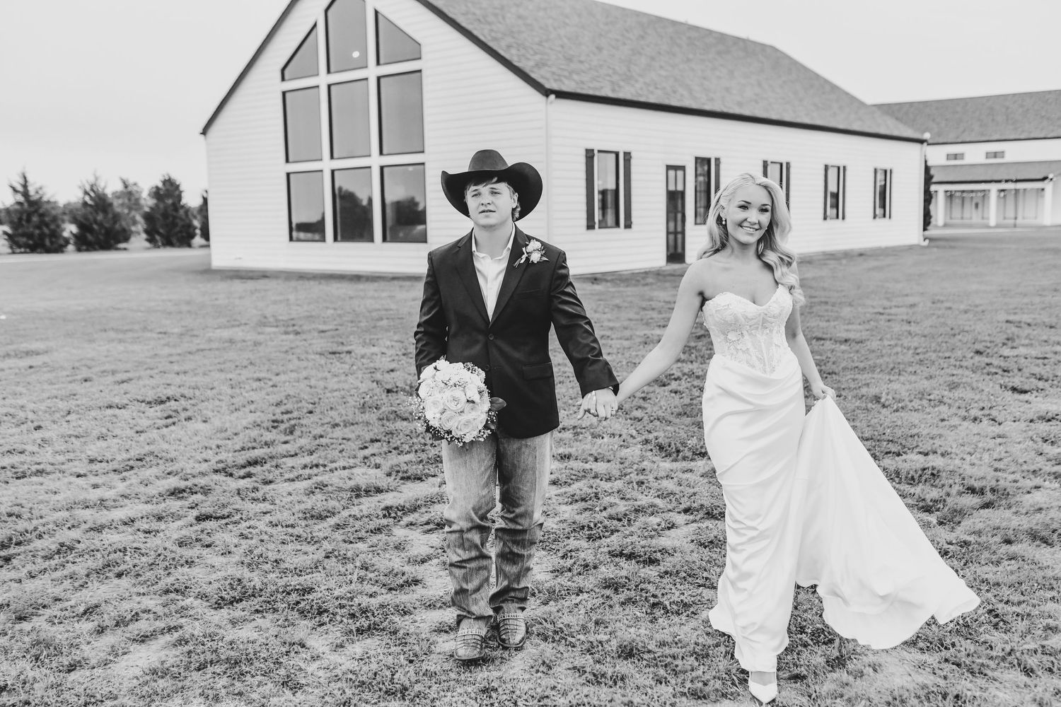 Newlyweds embracing at sunset in front of wedding chapel