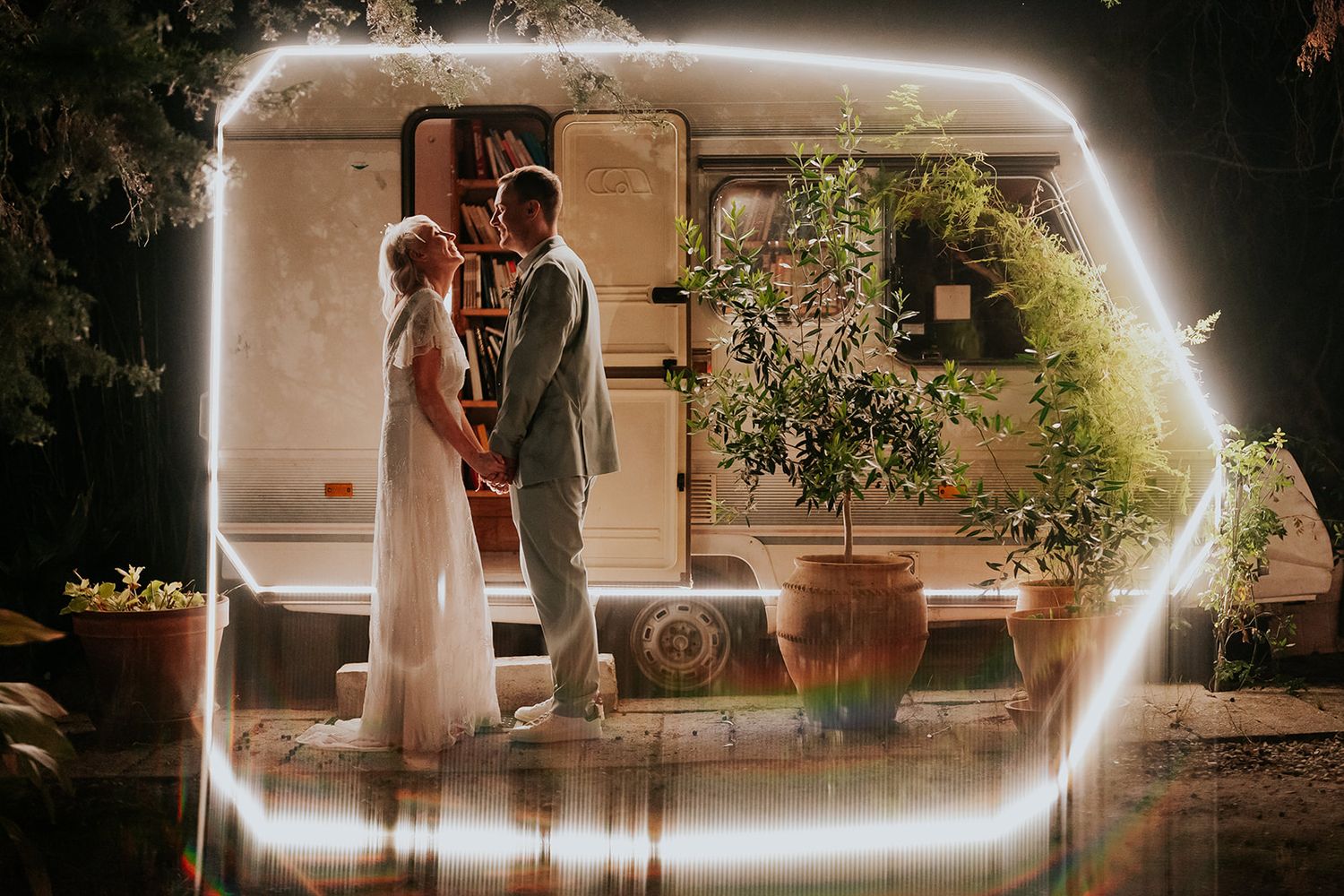 Ethereal wedding portrait with light leaks and rustic architecture in the background.