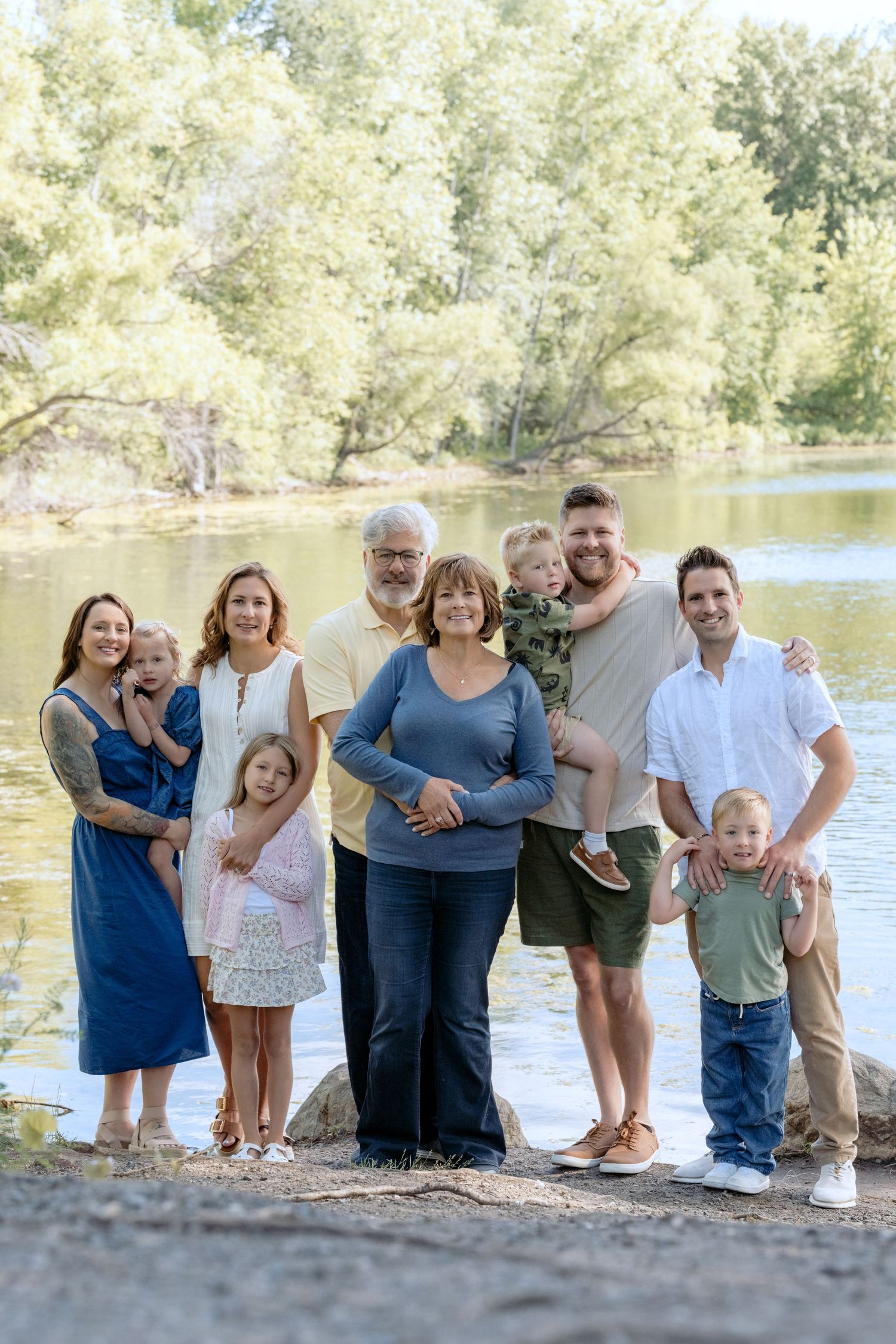 full multi generational family portrait in front of the water at powers lake park in woodbury mn