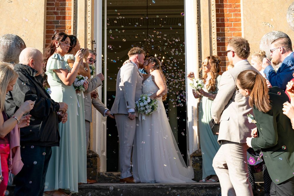Crowcombe Court Wedding confetti Bride and Groom kissing