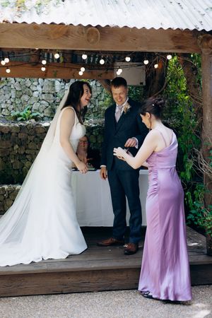 Bride and groom laughing during wedding portraits.