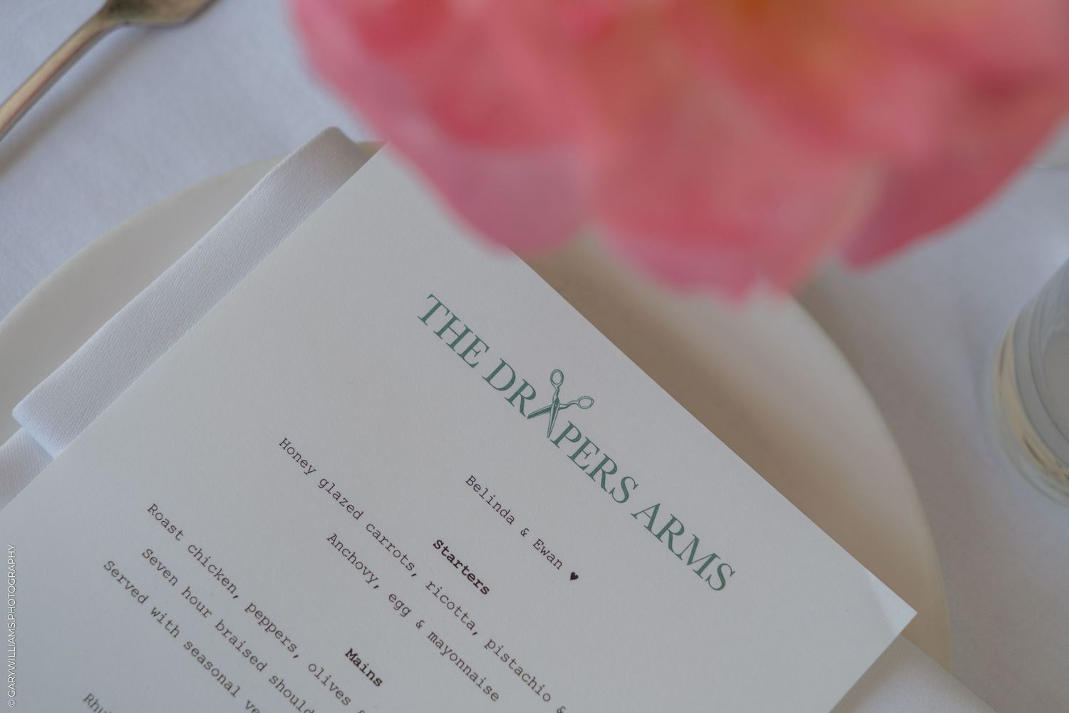 The Drapers Arms restaurant menu card on elegant white table setting.