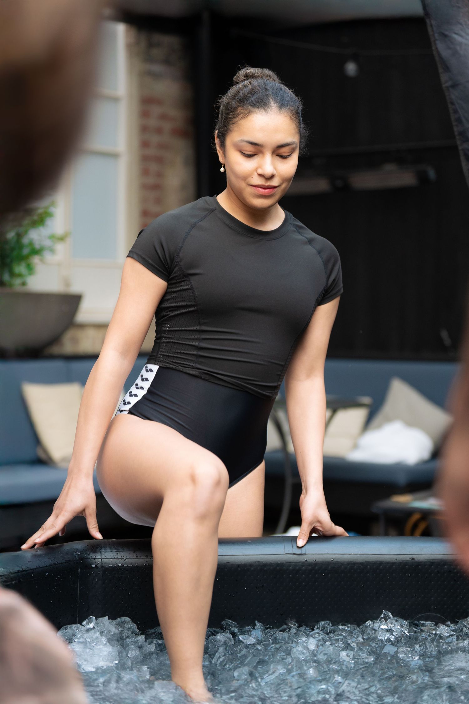 Woman performing side plank exercise on blue yoga mat during workout.