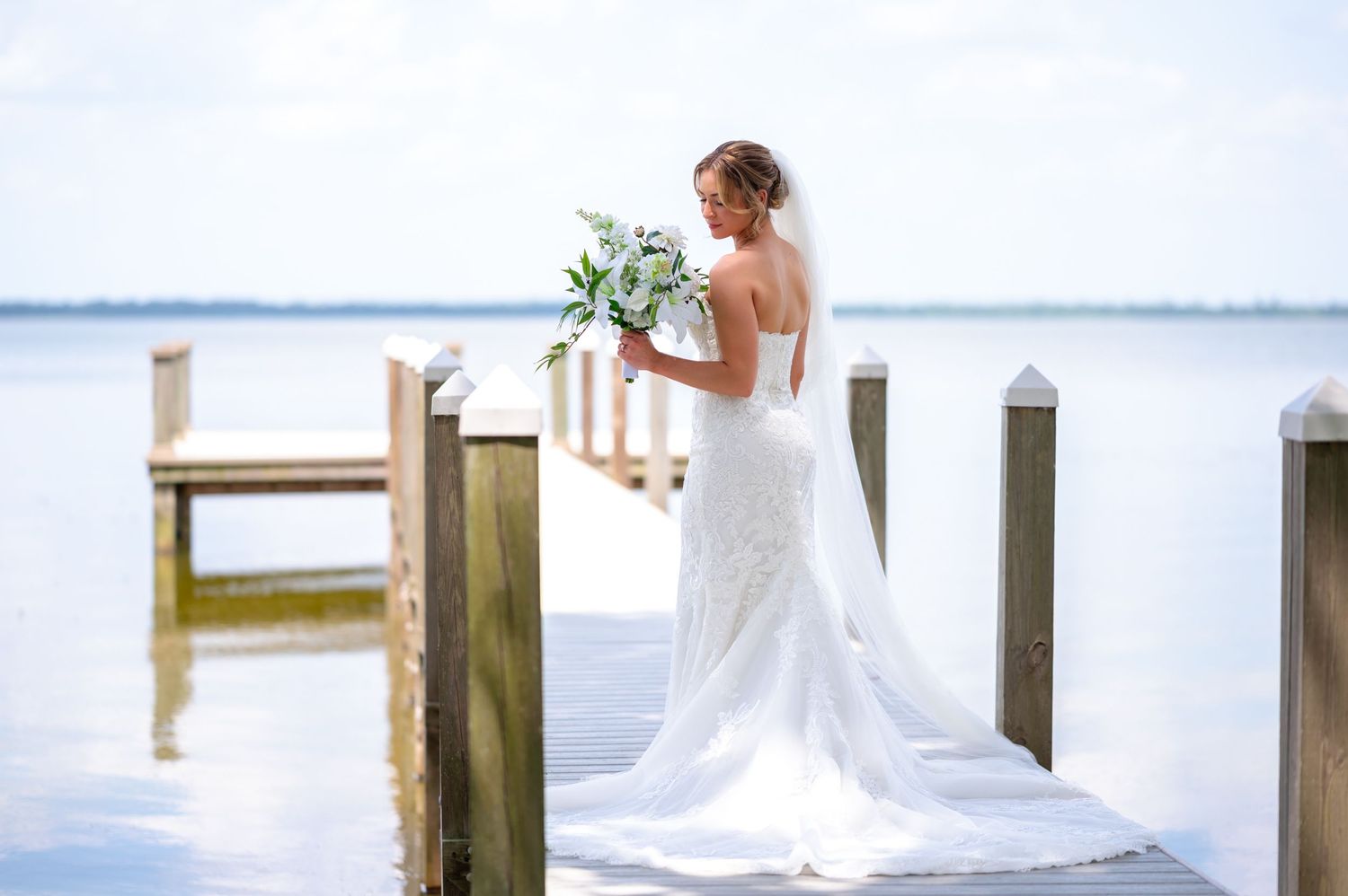 A beautiful bride portrait on the water, captured by South Florida wedding photographers.