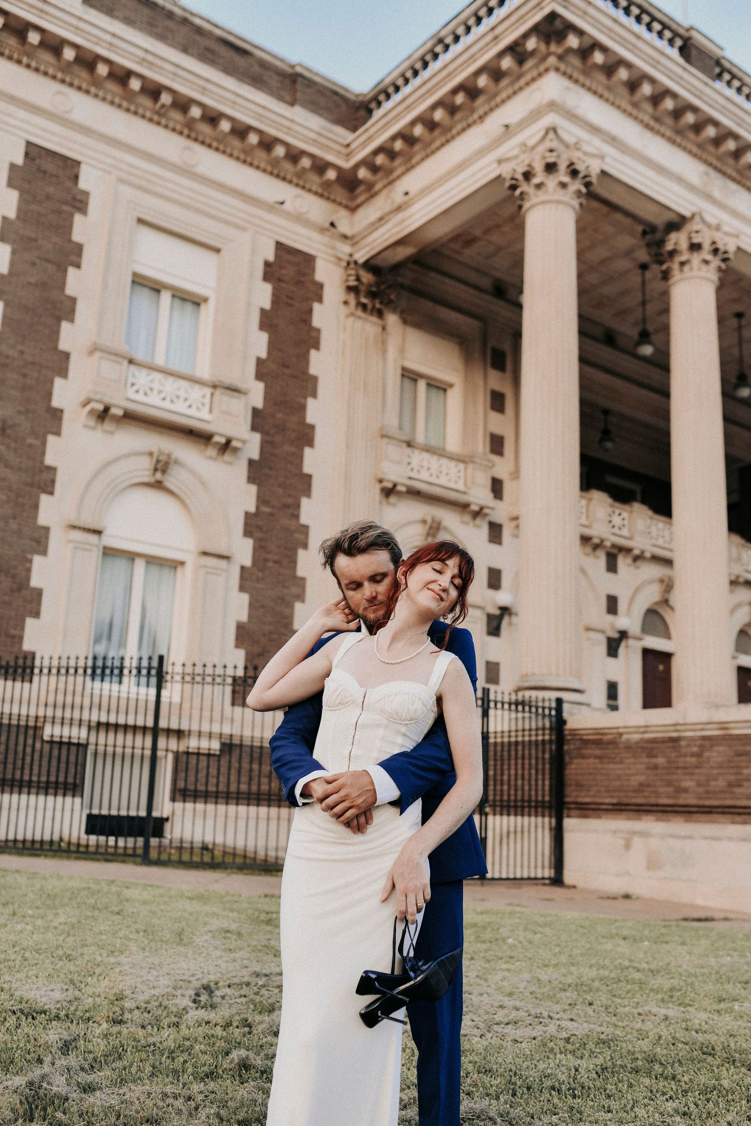 Engaged couple standing outside Scottish Rite Cathedral