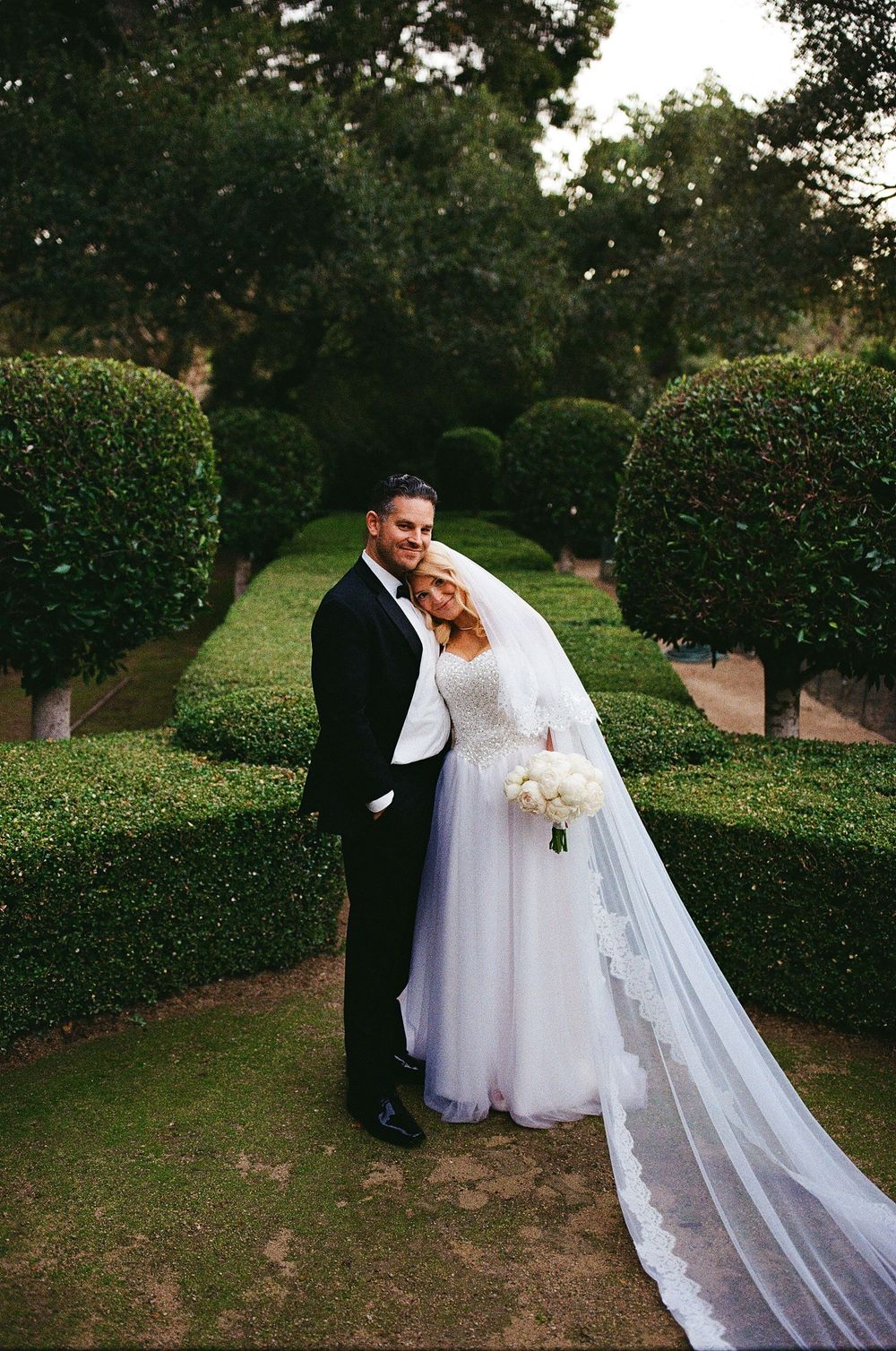 elegant vintage inspired film photo of couple in wedding attire