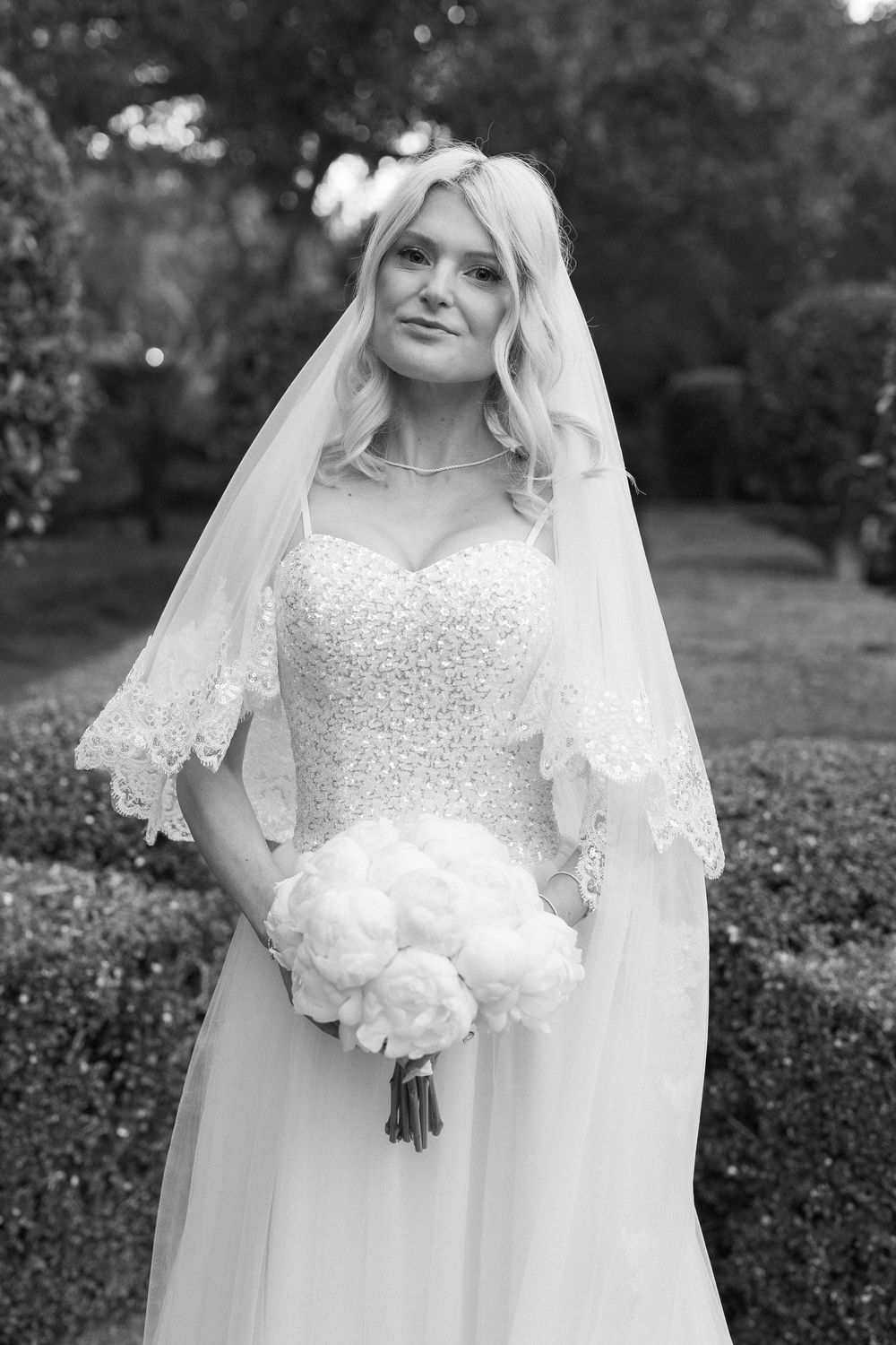 Santa Barbara bride shows veil and dress at wedding reception