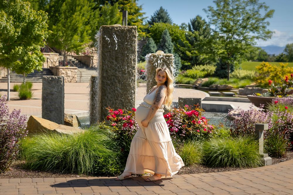 maternity photo woman standing by water feature at Scentsy Commons Meridian Idaho Milestones Portraits