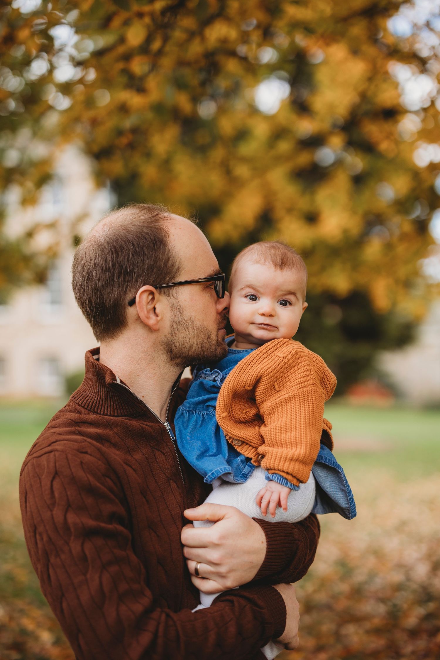 A couple sharing a joyful moment outdoors on a sunny afternoon in a park setting.