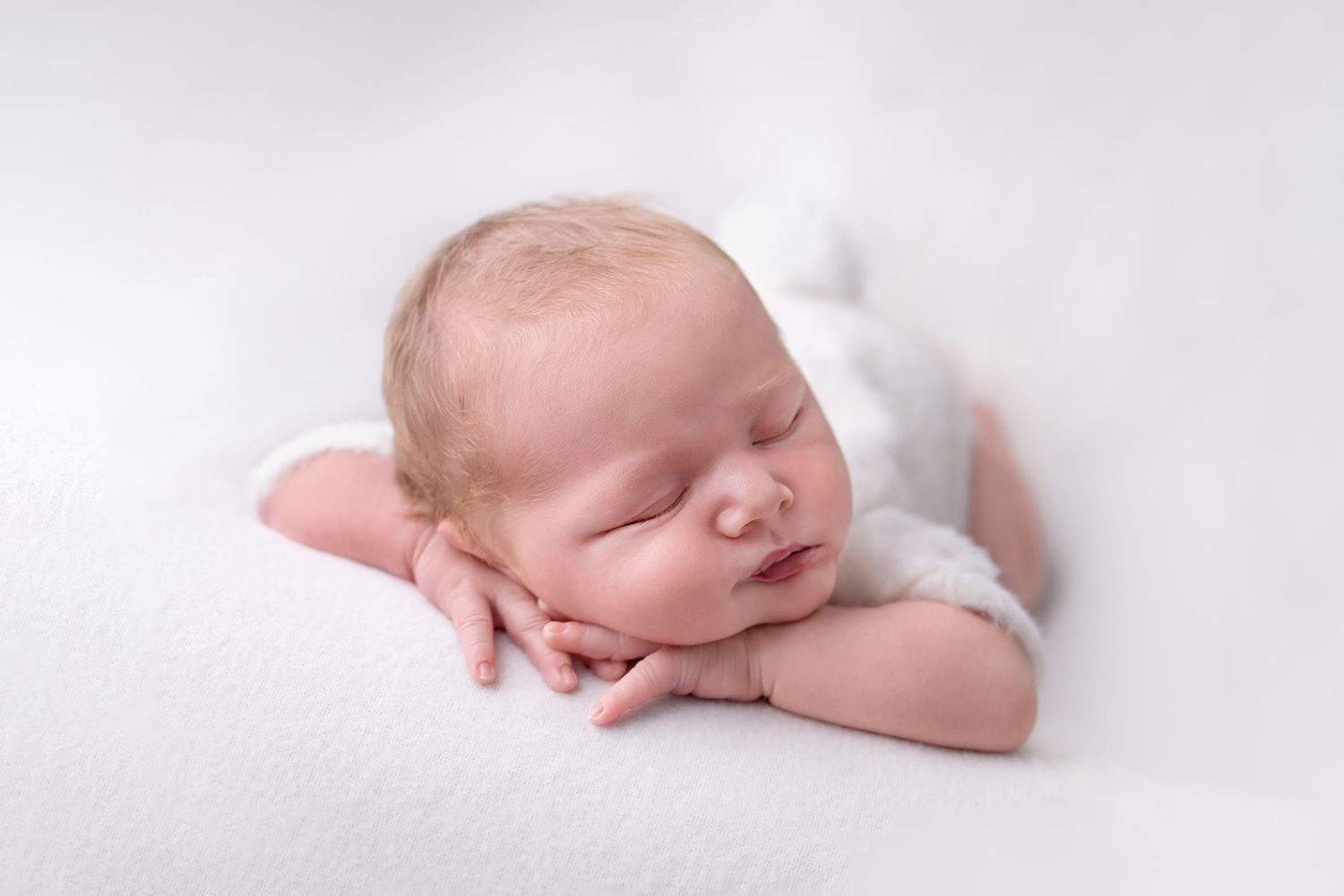 newborn baby photographer ashford kent chin on hands pose natural style cream white romper