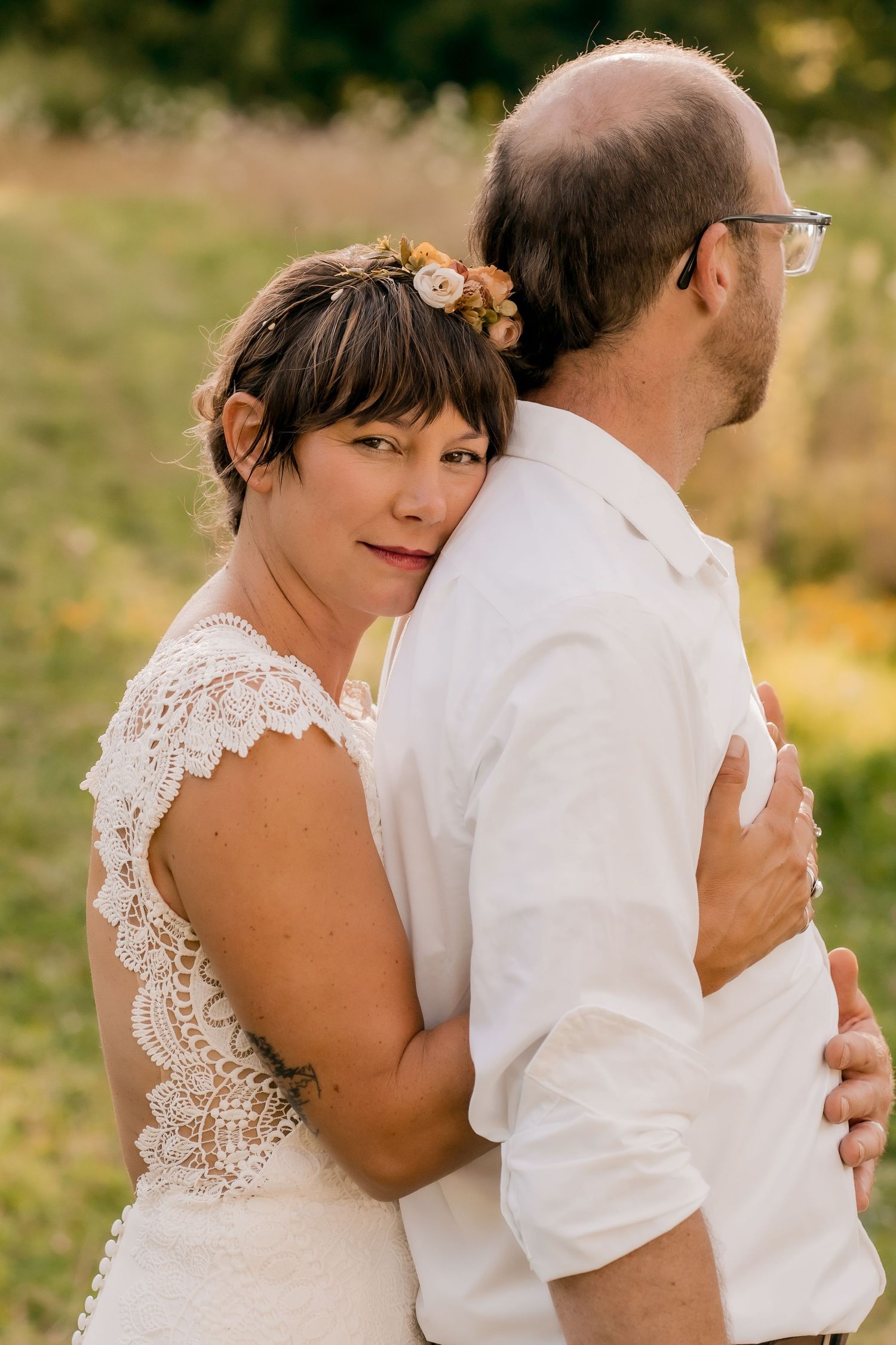 Intimate wedding portraits showing tender moments between a couple in white and khaki attire.