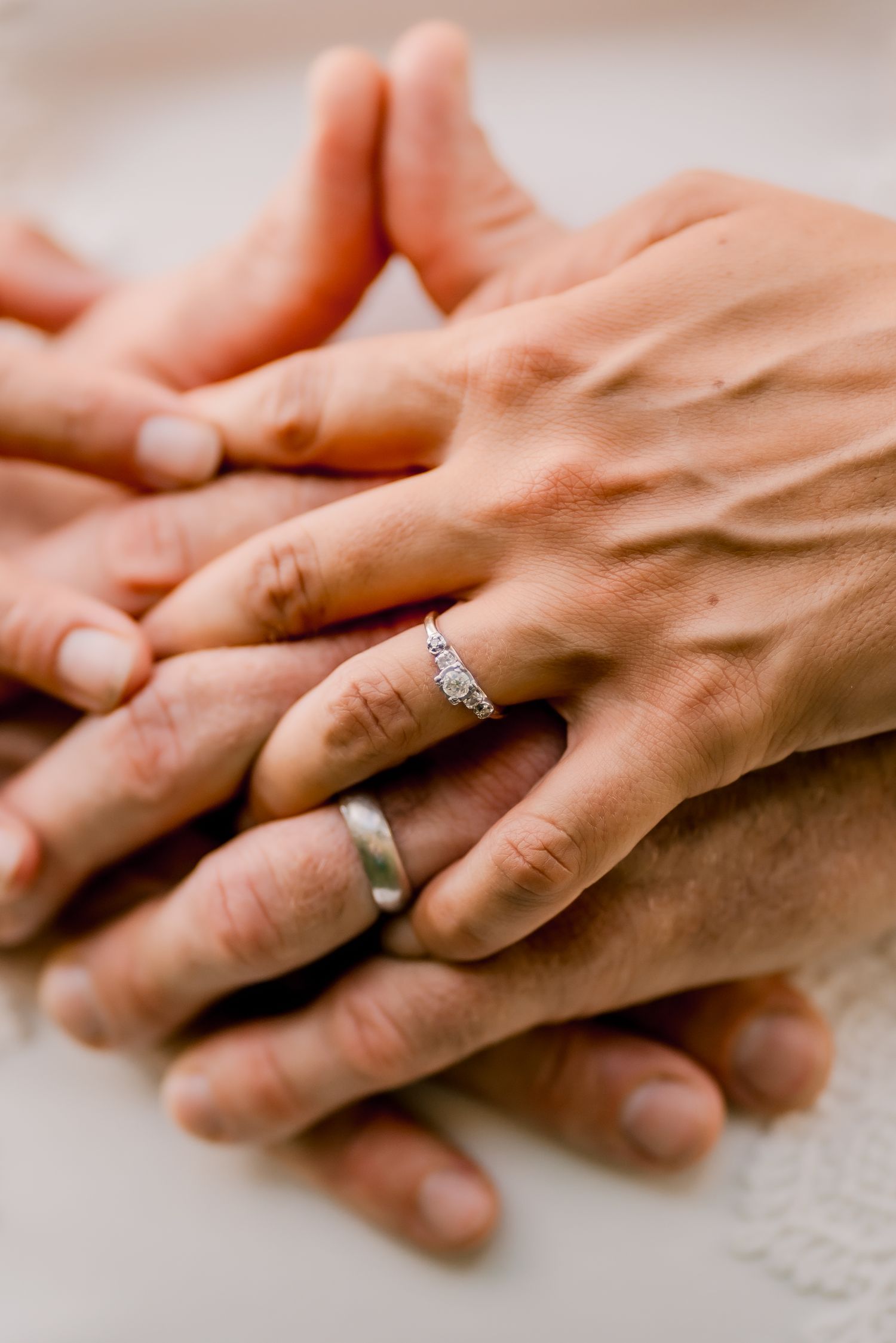 Close-up shots of hands with wedding rings showing tender moments of touch and connection.