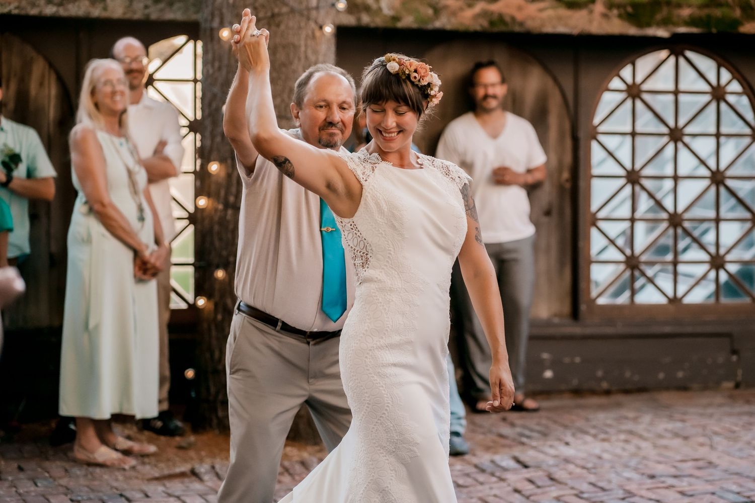 Joyful dancing and celebration captured at an indoor wedding reception.