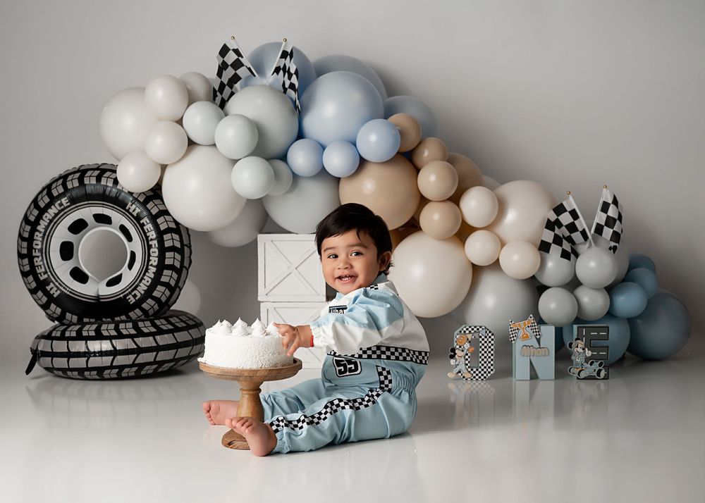 racecar theme birthday photoshoot, Moreno Valley cake smash photography. cars theme balloon arch for first birthday photos in studio