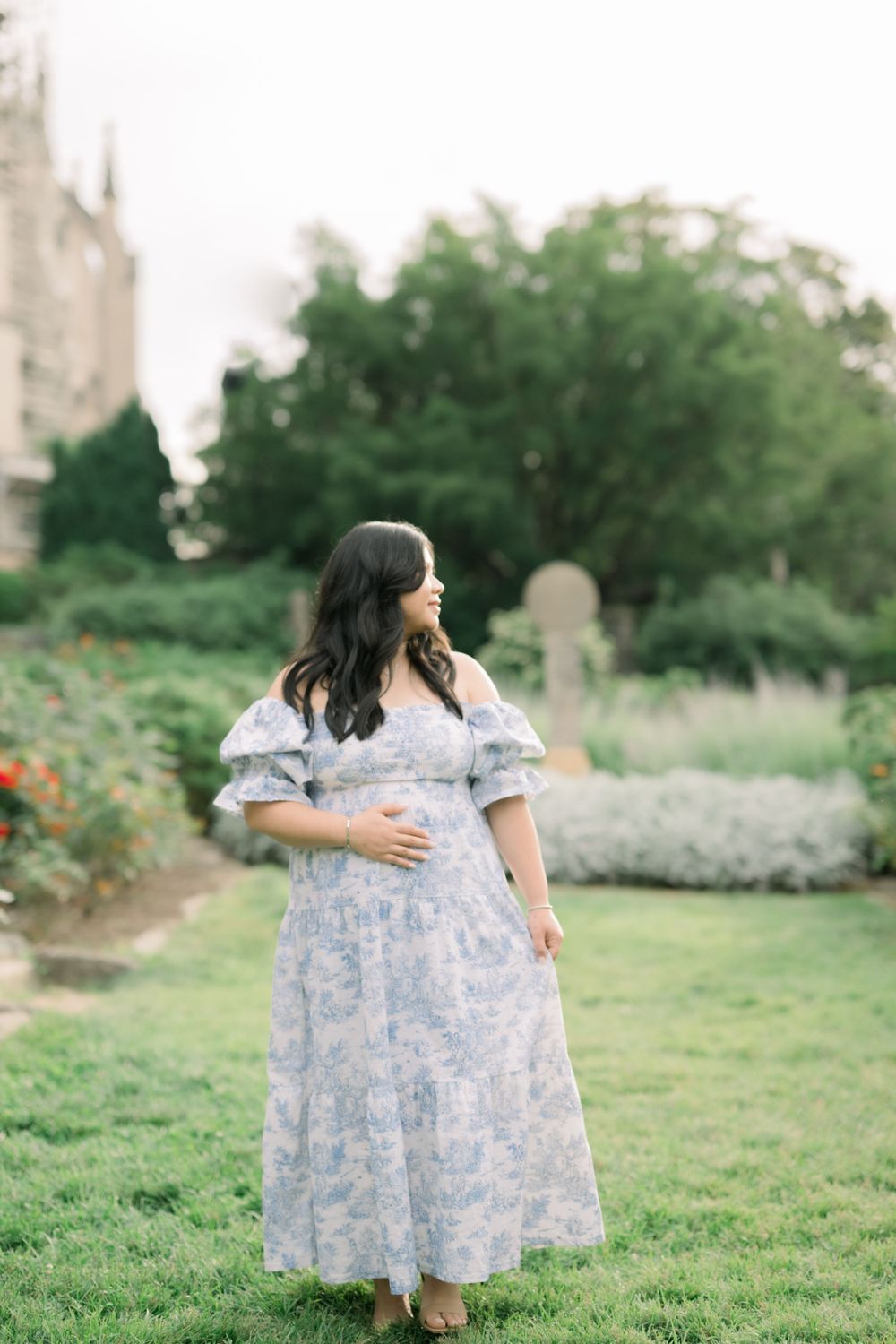 Woman in dress poses in the Bishop's Garden at the National Cathedral in Washington DC taken by a northern virginia maternity photographer