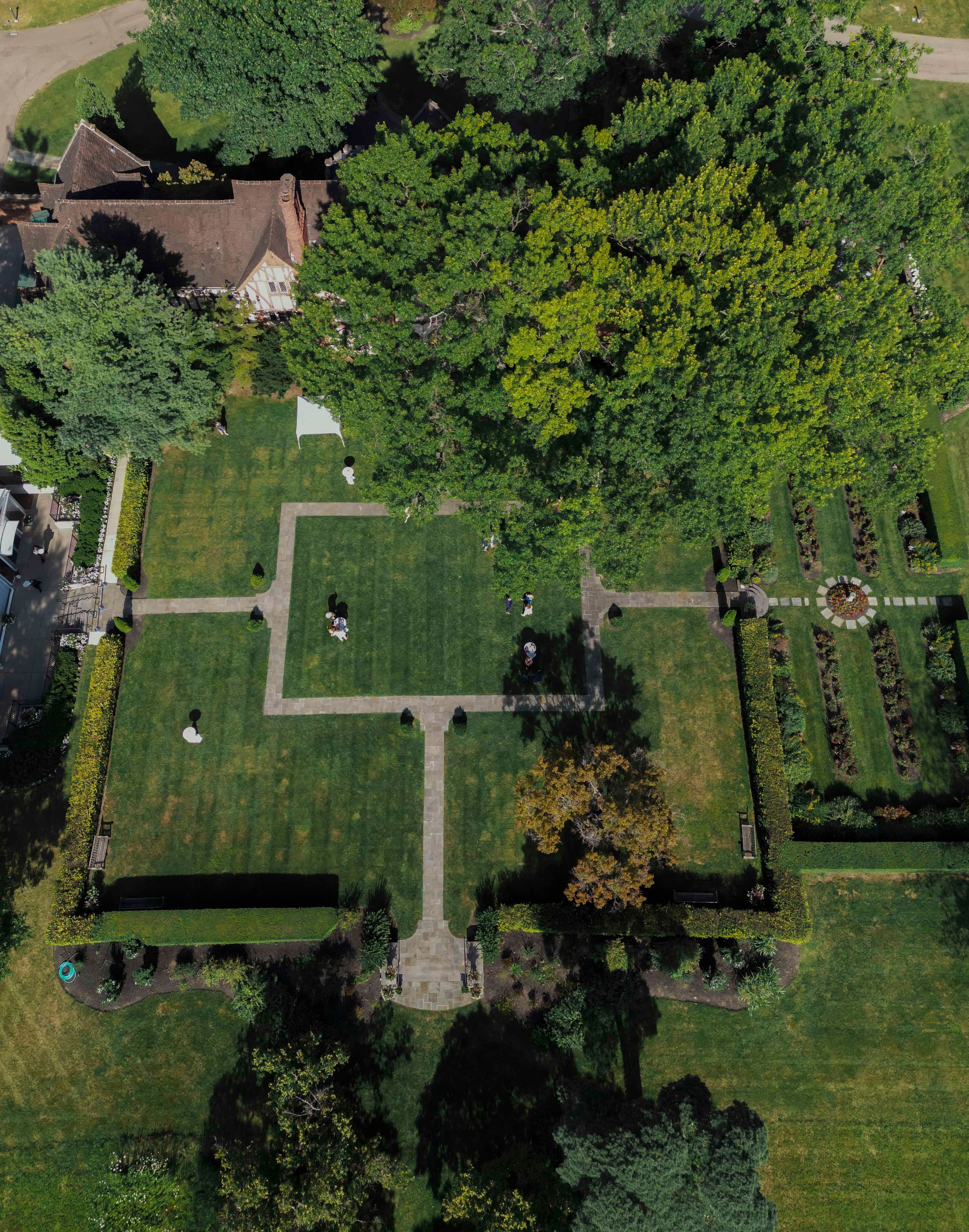 Aerial view of a formal garden with manicured lawns and geometric pathways.