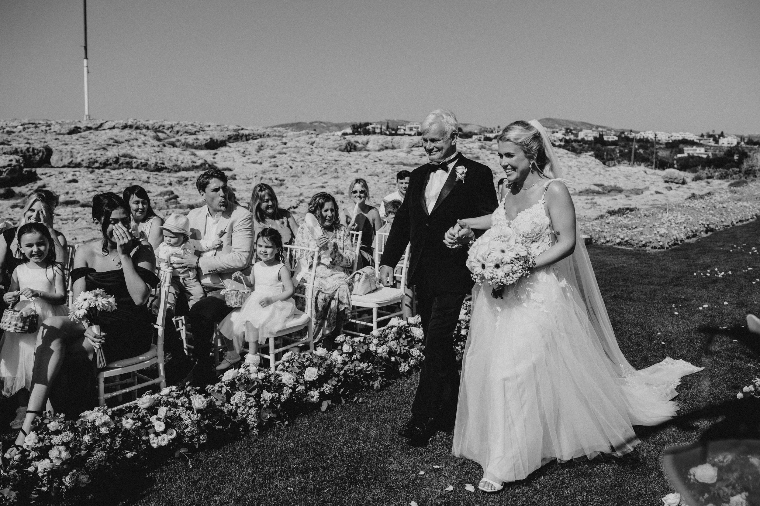 Black and white wedding photographs arranged in a row showing outdoor ceremony and celebration moments.