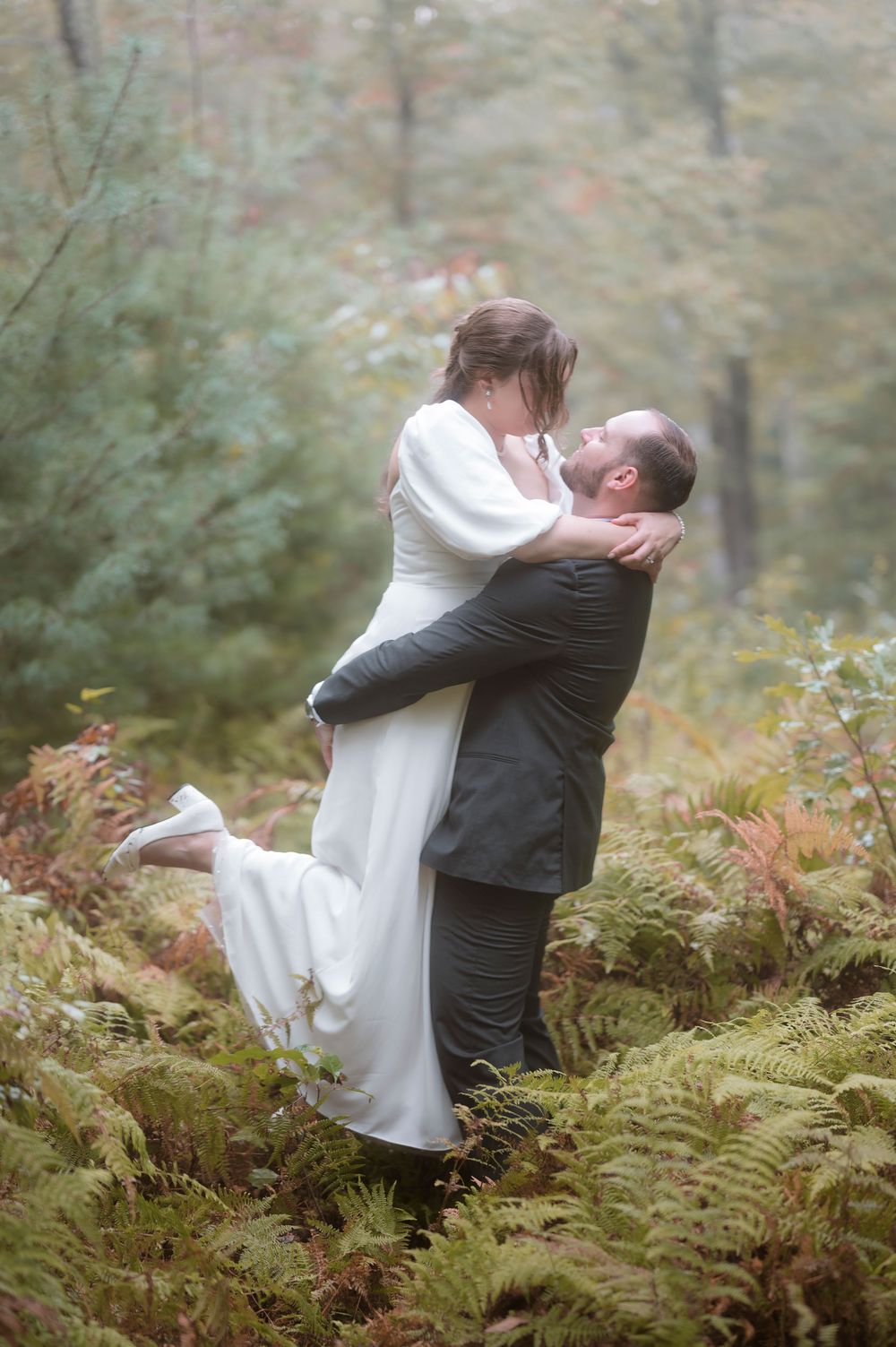A romantic sequence of intimate wedding photos captured in a misty fern-covered forest setting.