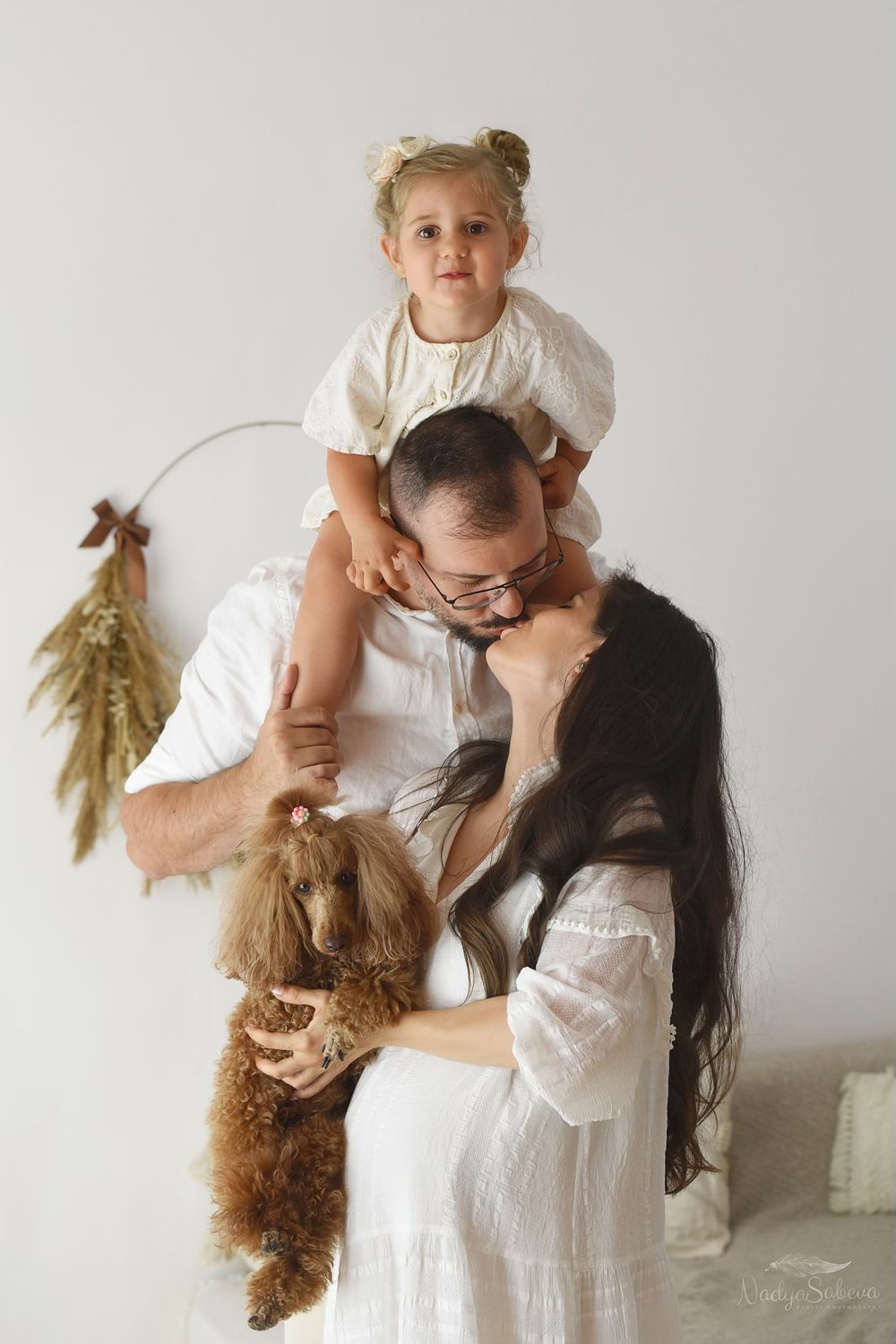 Series of tender moments in white outfits between parent and child playing and embracing against neutral background.