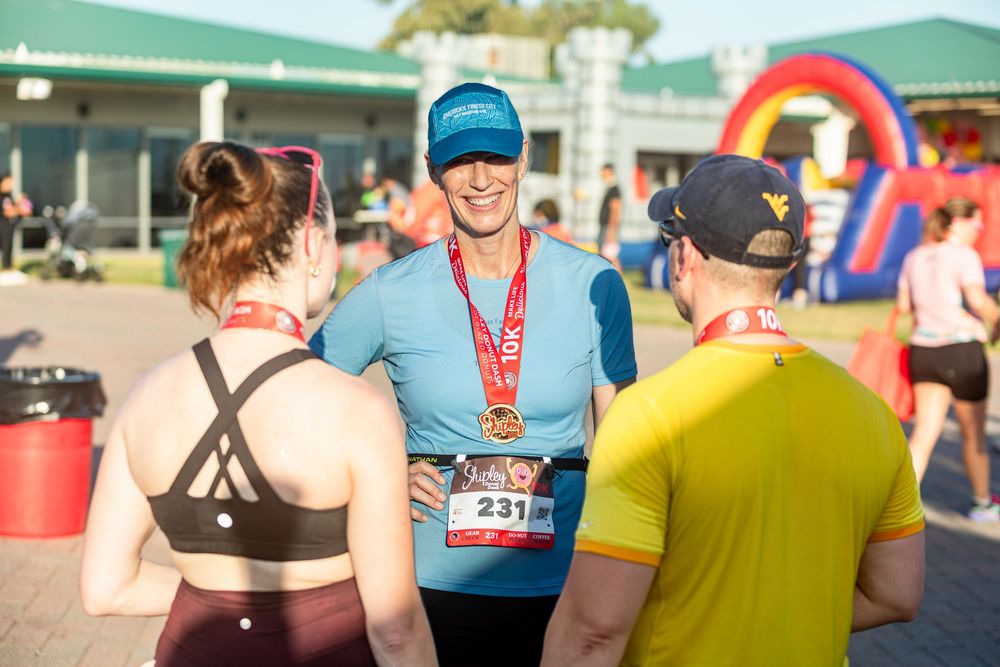 Community 5K run photography in Houston capturing finish line moments candid photo of runners at the Shipley Donut Dash 5K race in Houston T