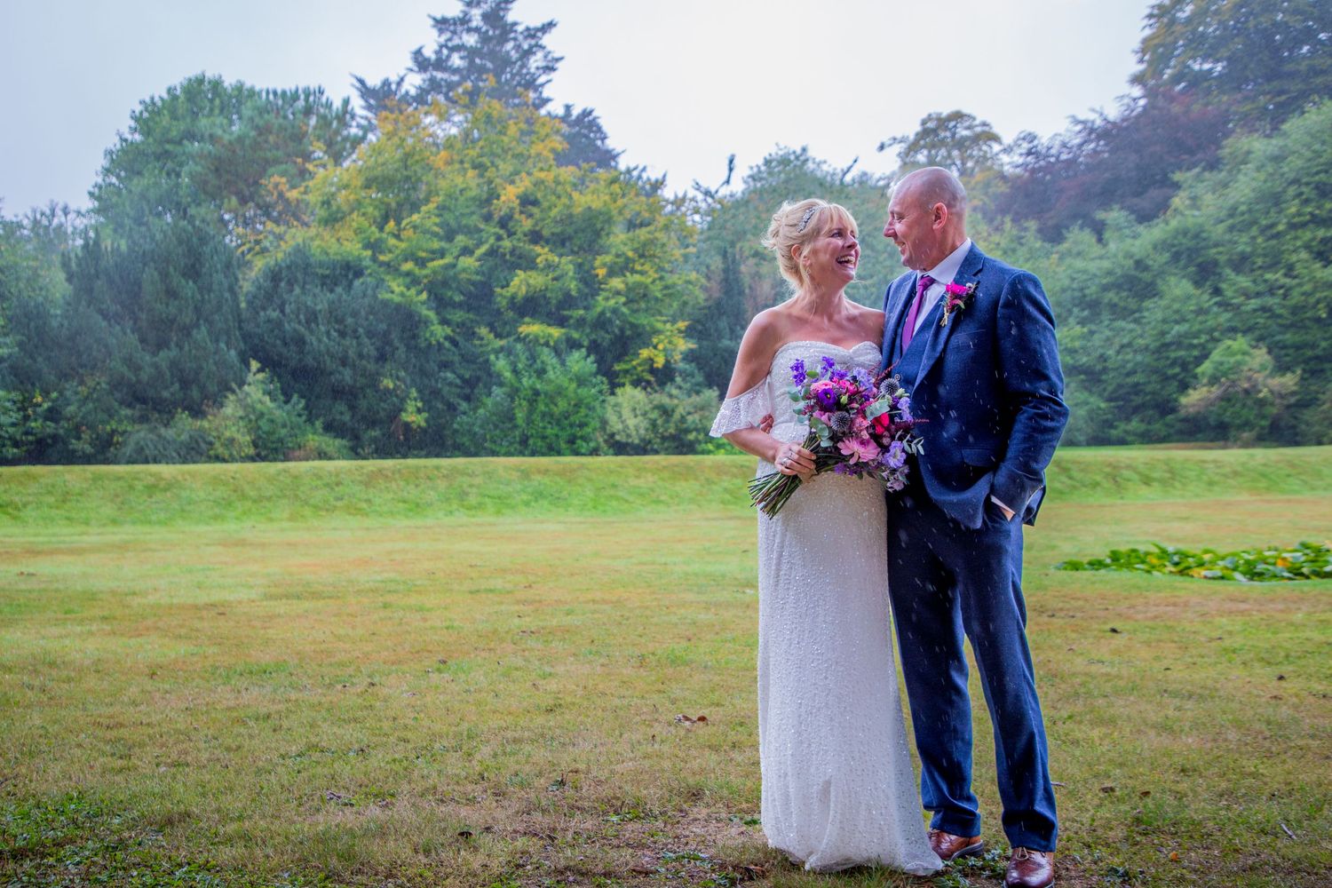 Candid photo of bride and groom at an outdoor wedding venue, Totnes, Devon