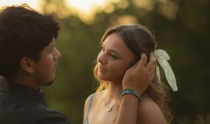 Young couple gazing at each other during a romantic outdoor portrait at golden hour.