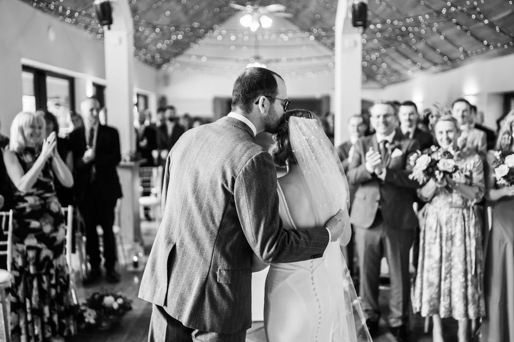 A black and white photo montage of wedding reception scenes showing dancing couples and guests celebrating on the dance floor.