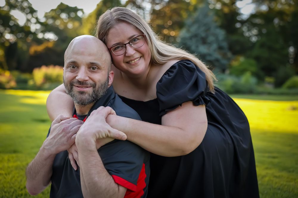 Casual outdoor engagement photo session with couple in relaxed poses.
