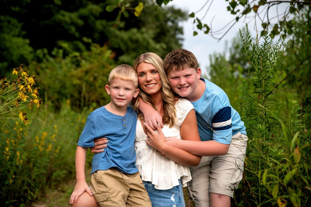 Family of three enjoying an outdoor photography session in St. Marys, Ohio