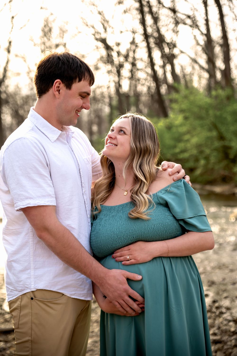 Expectant couple embracing during a maternity photography session at Tawawa Park in Sidney, Ohio
