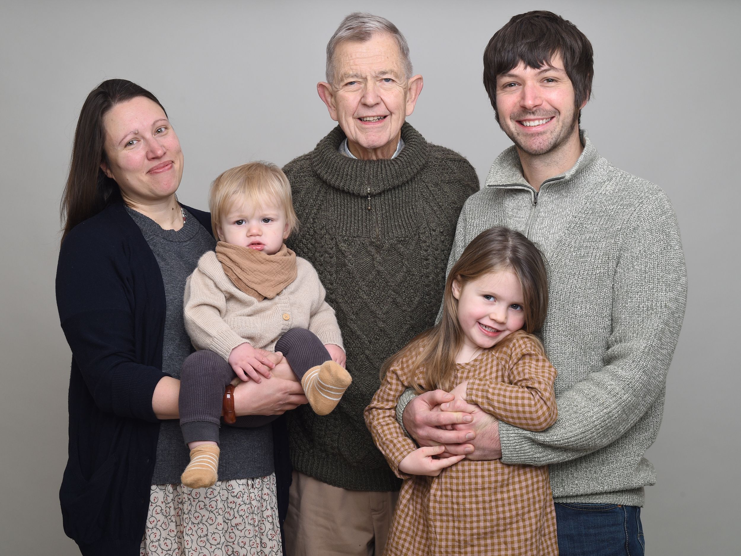 Three generations get together for studio family photoshoot on grey. Photographer Abigail's Studio, High Wycombe