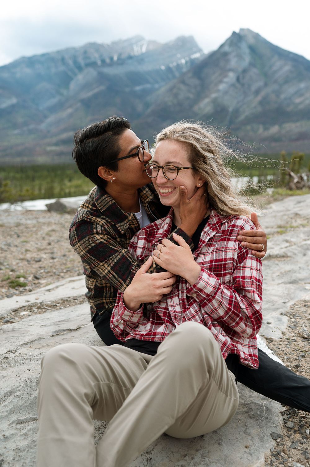A romantic mountain engagement photoshoot with dramatic mountain peaks in the background.