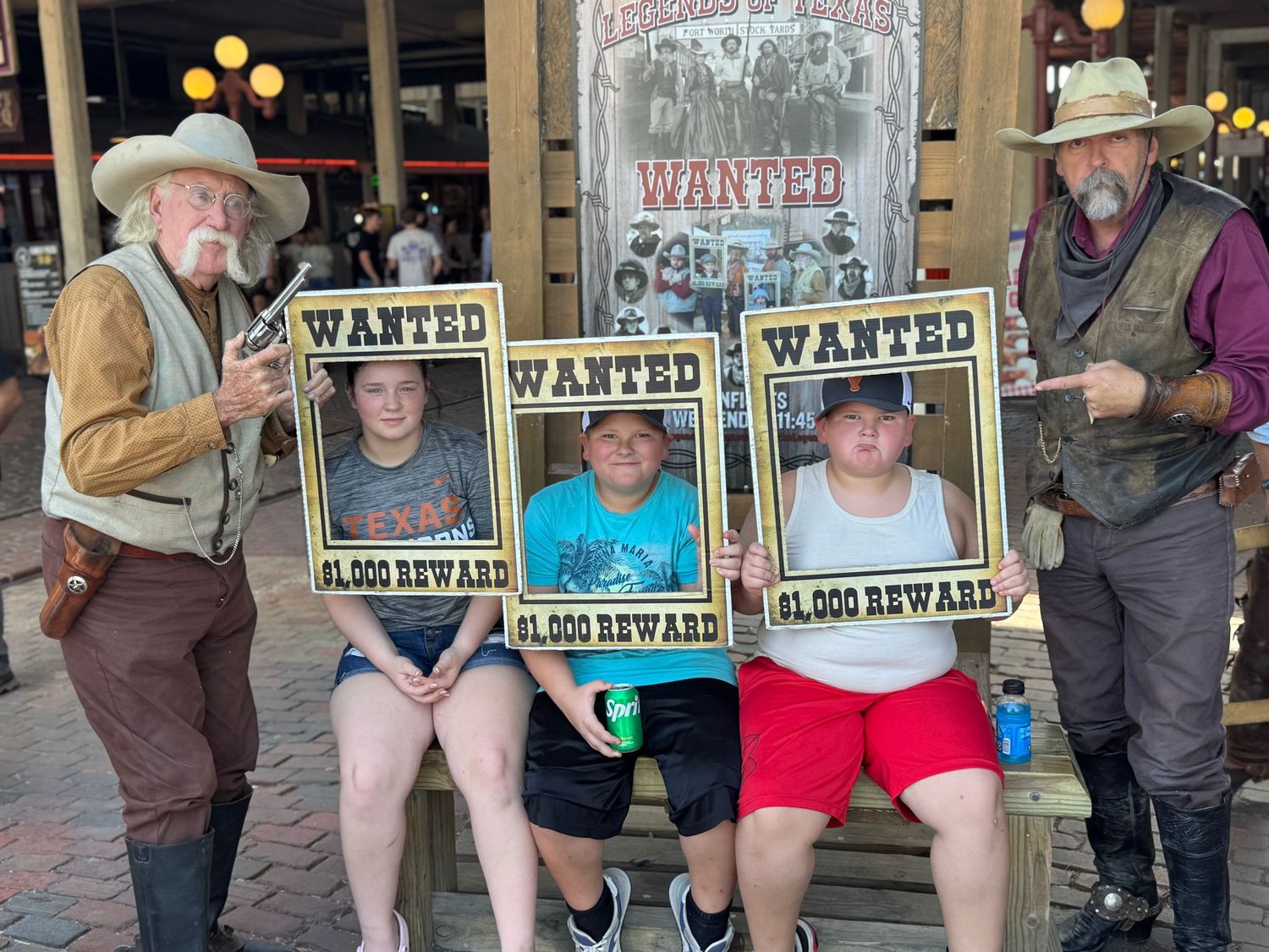 Western-themed photo setup with wanted posters and cowboy props.